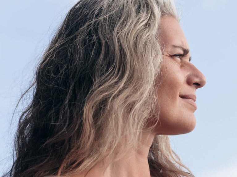 side profile of mature woman with gray hair